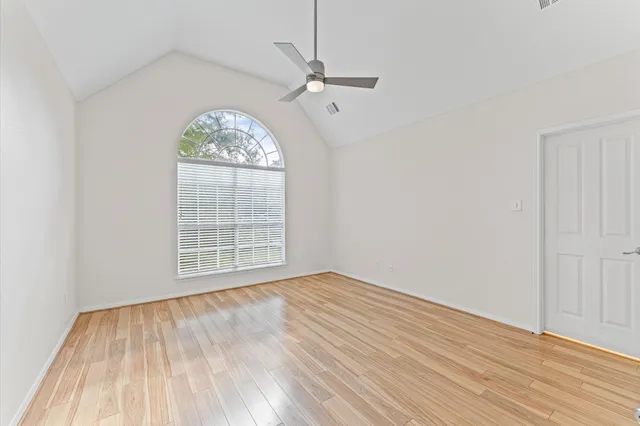 wooden floor in an empty room with a window