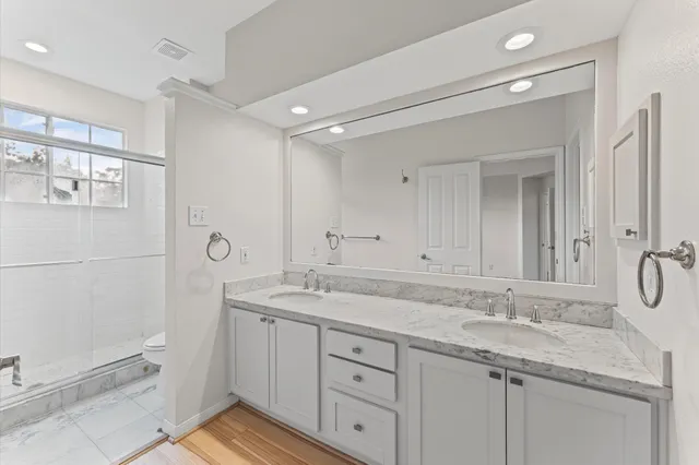 a bathroom with a granite countertop sink mirror and double
