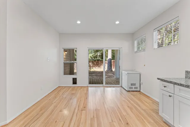 a view of a room with wooden floor and window