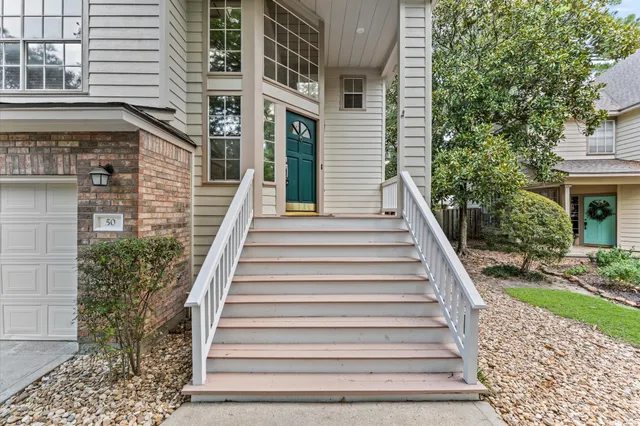 a view of a house with backyard and white walls