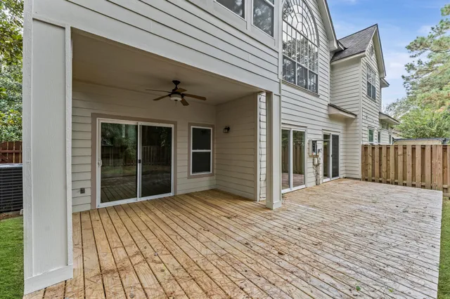a view of backyard with large window and wooden floor