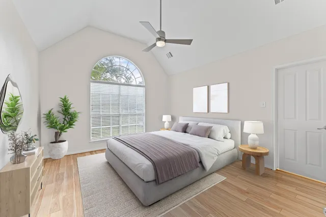 a bedroom with a large bed and a large window