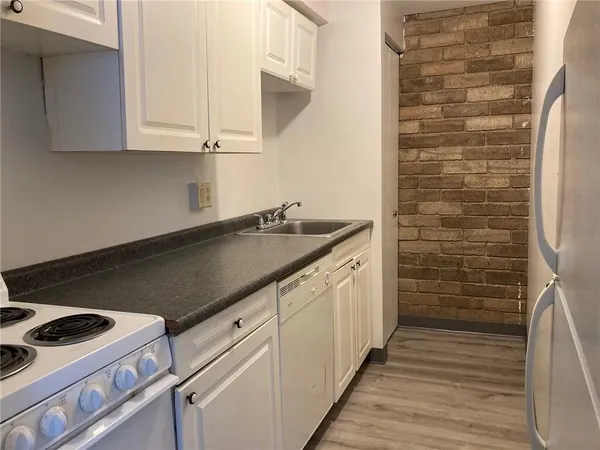 a kitchen with a sink and cabinets