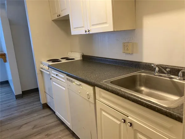 a view white cabinets and sink
