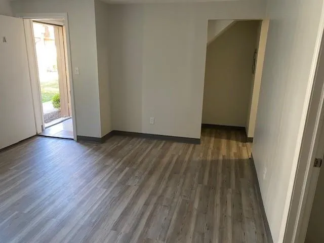 a view of wooden floor in a room next to a window