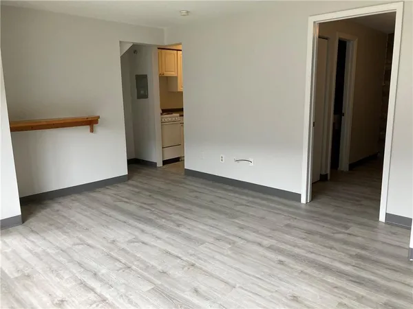 an empty room with wooden floor and closet