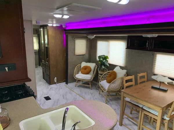 a living room with furniture and kitchen view