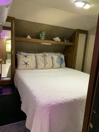 a large bed sitting in a bedroom next to a window