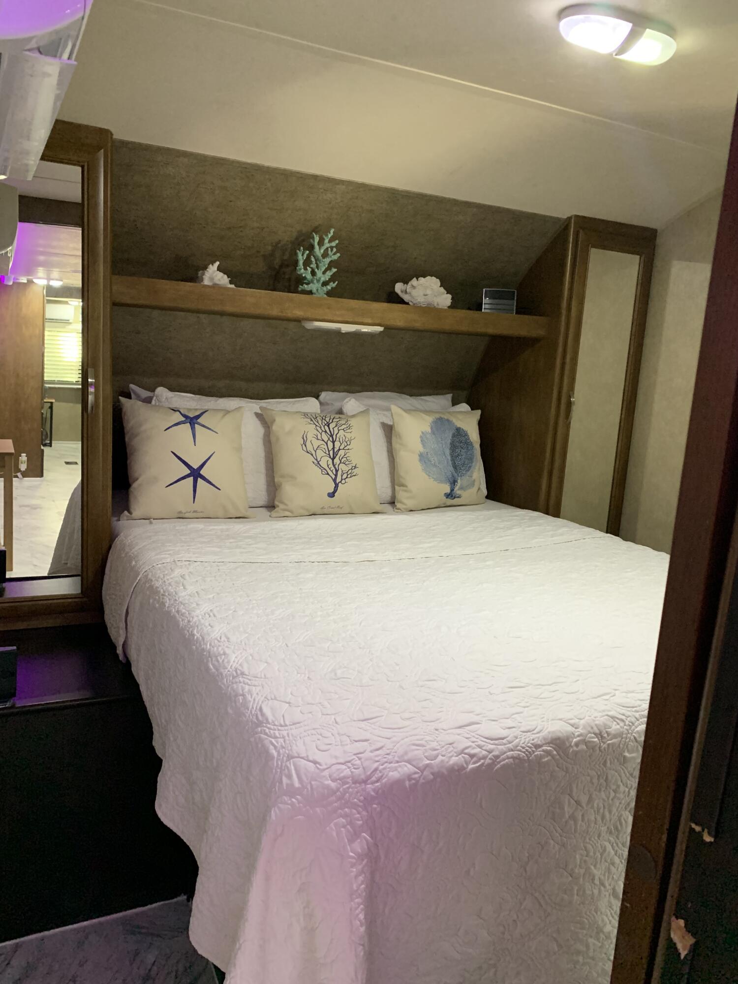 325 Calusa Street, Unit 120 Key Largo, FL 33037 - Photo 2 of 20 a large bed sitting in a bedroom next to a window
