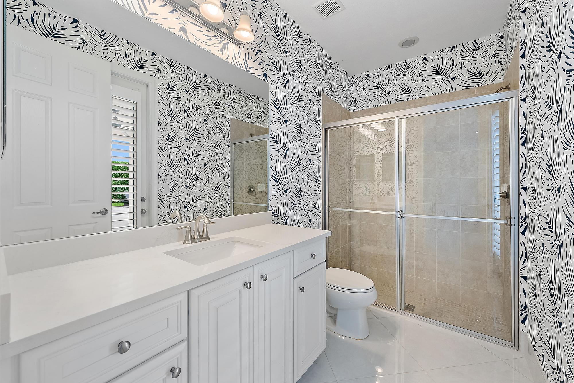 314 Rudder Cay Way Jupiter, FL 33458 - Photo 25 of 66 a bathroom with a sink a toilet and shower