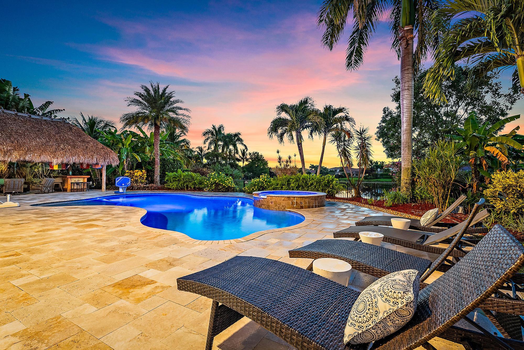 314 Rudder Cay Way Jupiter, FL 33458 - Photo 34 of 66 a view of a swimming pool with lounge chairs