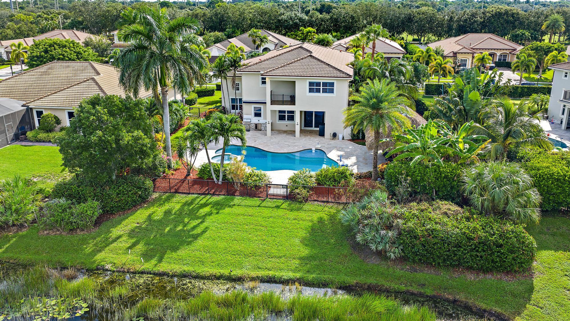 314 Rudder Cay Way Jupiter, FL 33458 - Photo 50 of 66 a aerial view of a house with swimming pool lawn chairs and a yard