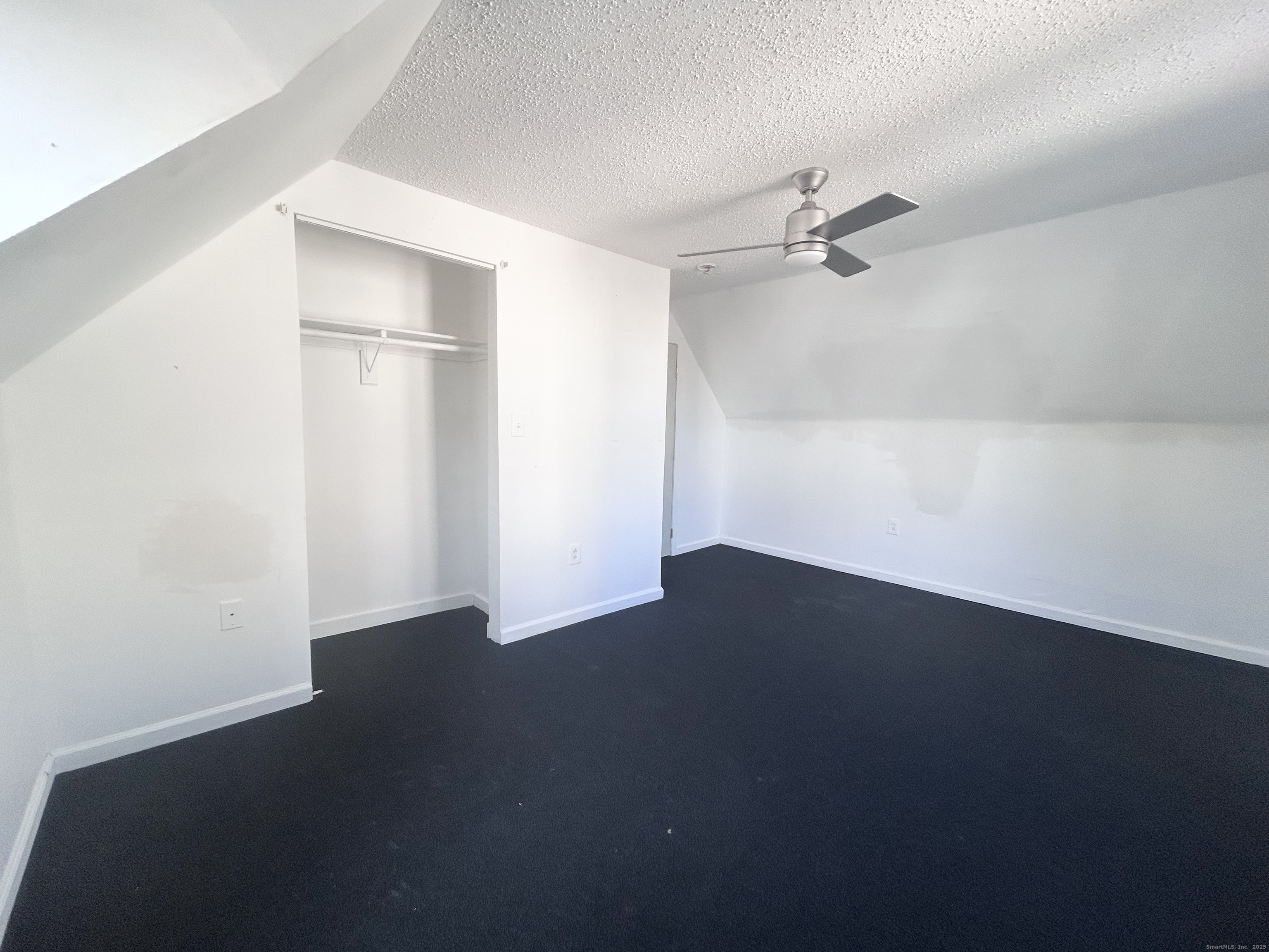 20 Hedge Avenue Norwich, CT 06360 - Photo 12 of 14 an empty room with wooden floor ceiling fan and windows