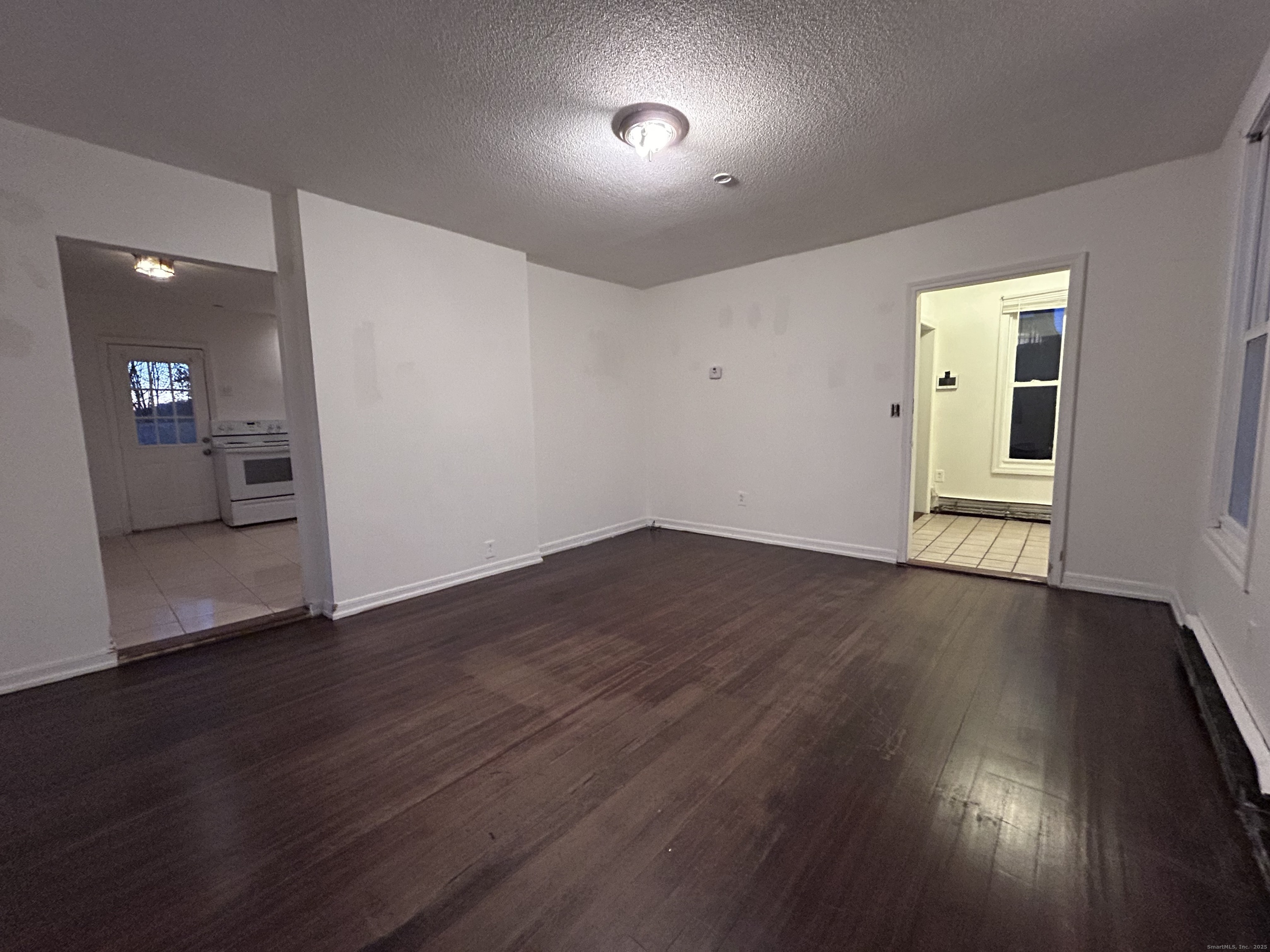 20 Hedge Avenue Norwich, CT 06360 - Photo 5 of 14 an empty room with wooden floor and windows