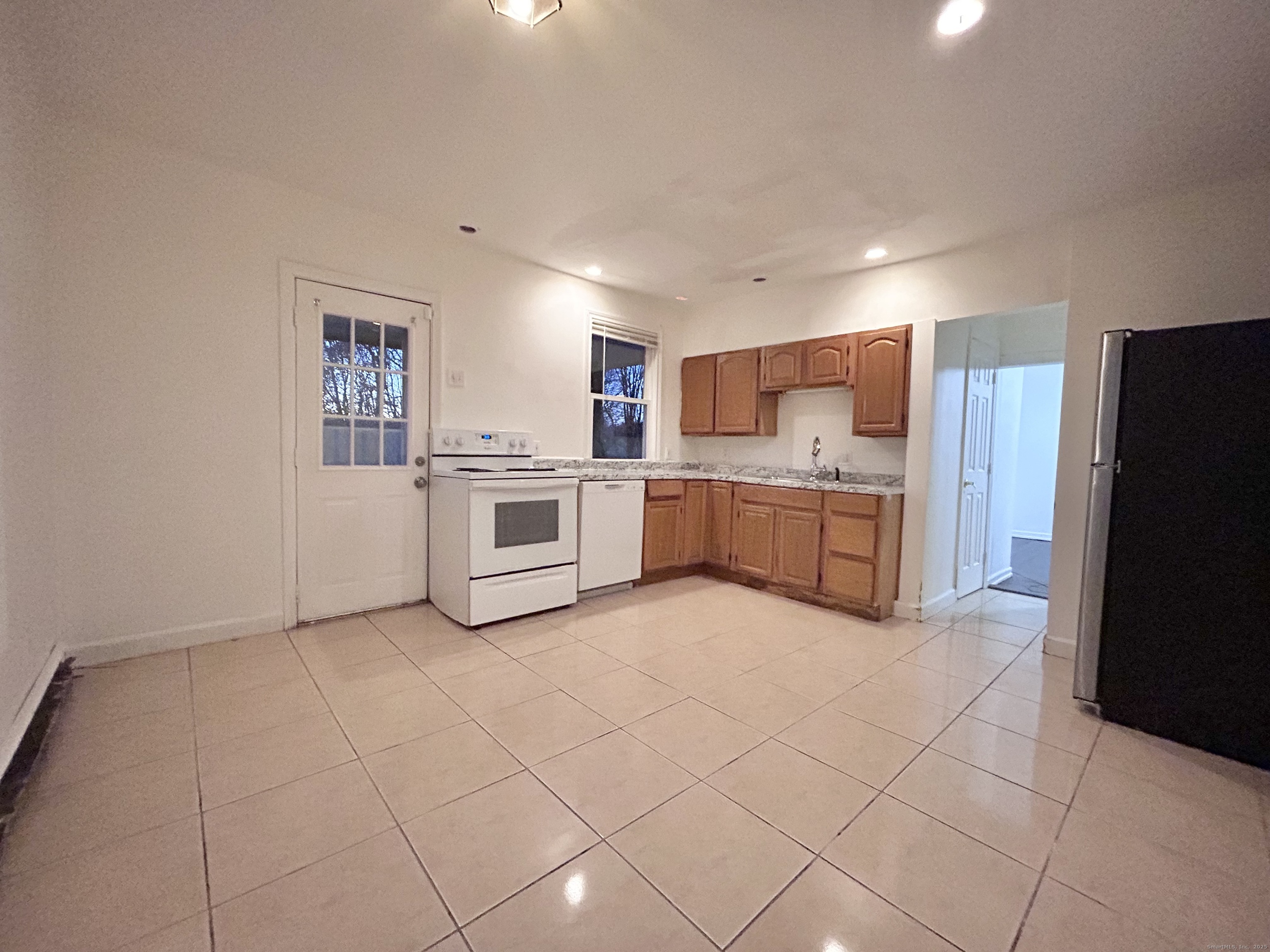 20 Hedge Avenue Norwich, CT 06360 - Photo 6 of 14 a kitchen with stainless steel appliances granite countertop a stove top oven a sink and a refrigerator