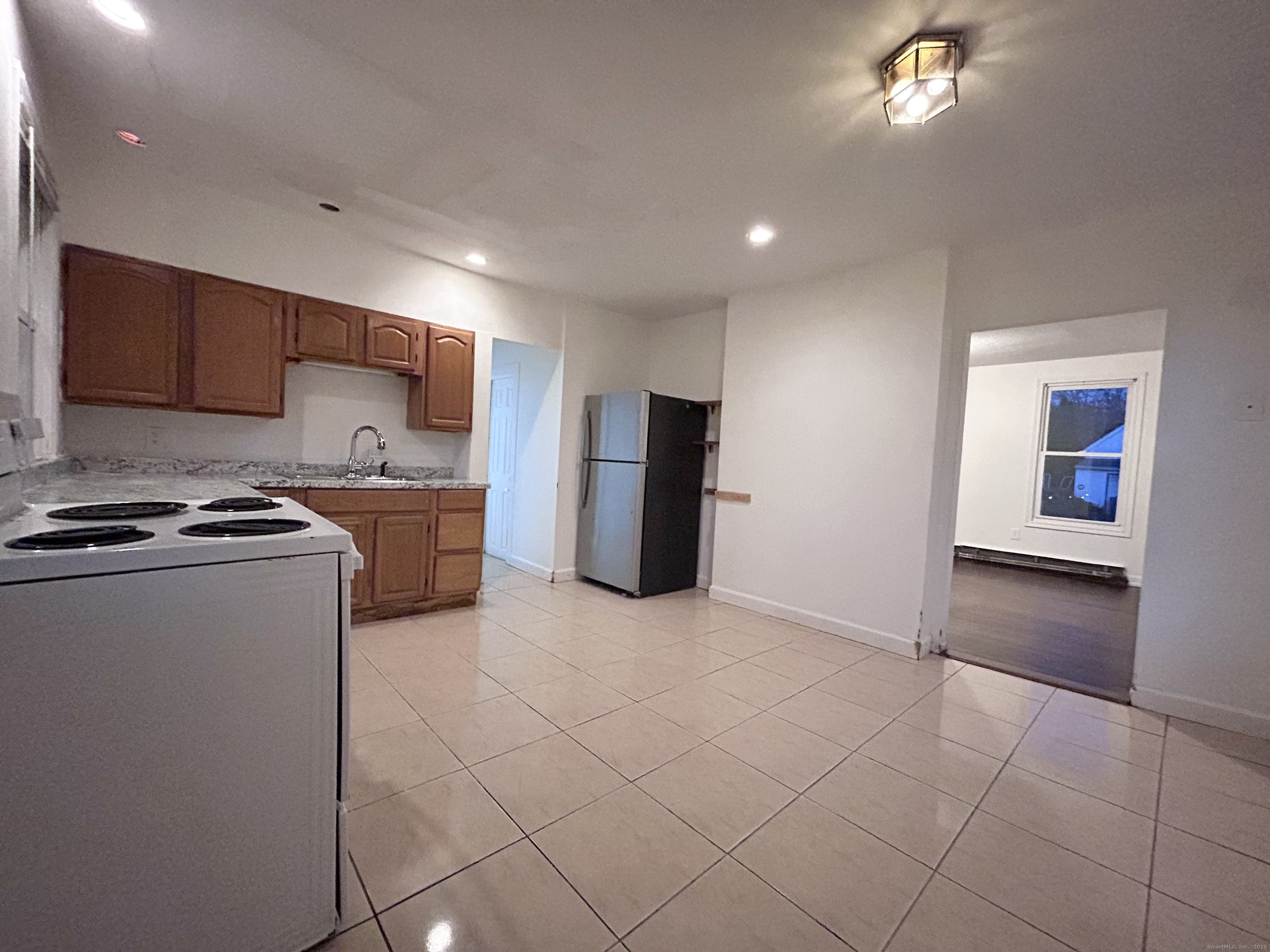20 Hedge Avenue Norwich, CT 06360 - Photo 7 of 14 a kitchen with a sink and a refrigerator