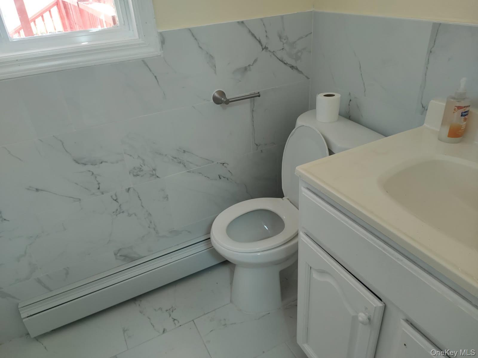 41 Woodbrook Drive Ridge, NY 11961 - Photo 14 of 15 a bathroom with a toilet and a sink