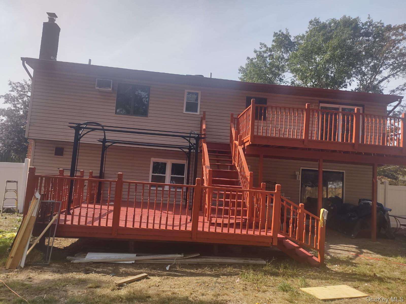 41 Woodbrook Drive Ridge, NY 11961 - Photo 15 of 15 a view of a house with a small deck