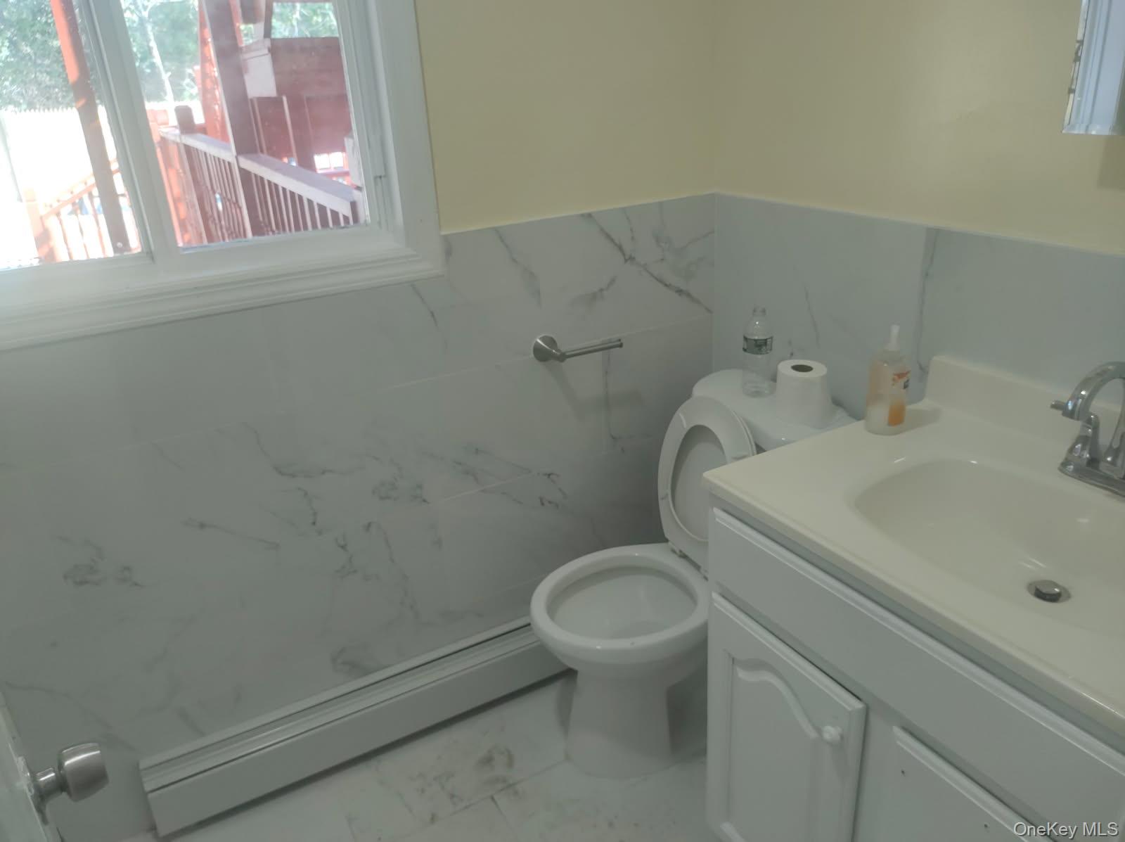 41 Woodbrook Drive Ridge, NY 11961 - Photo 3 of 15 a bathroom with a sink and a toilet