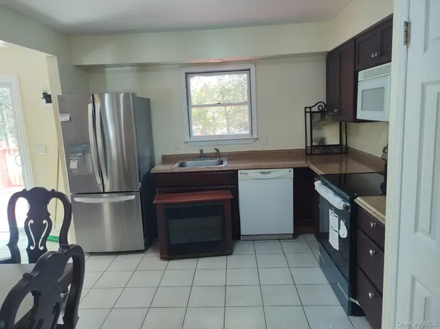 a kitchen with a stove a refrigerator and a sink