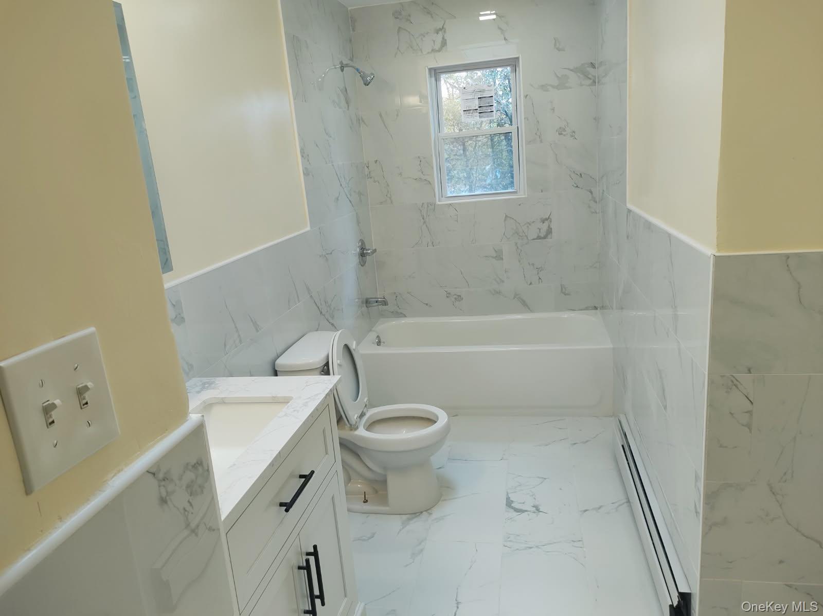 41 Woodbrook Drive Ridge, NY 11961 - Photo 9 of 15 a bathroom with a sink a toilet and shower