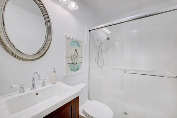 a bathroom with a sink toilet and shower