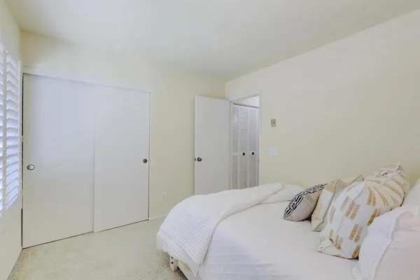 a bedroom with a bed and pillows