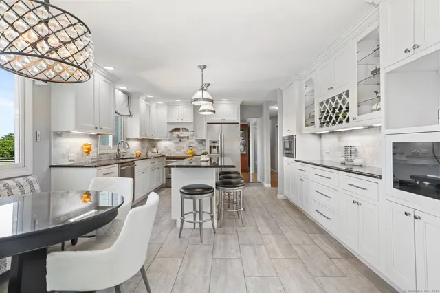 a kitchen with granite countertop a sink cabinets and window