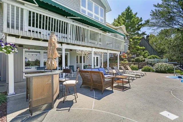 a view of a patio with couches table and chairs and potted plants