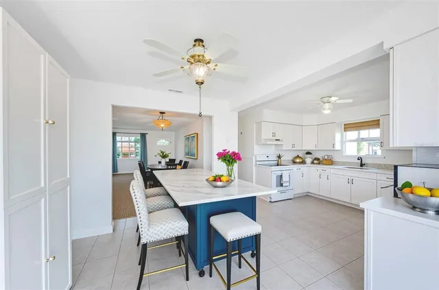 an empty room with a chandelier fan