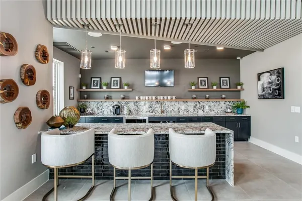 a kitchen with stainless steel appliances granite countertop a sink and a refrigerator