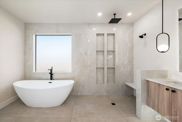 a bathroom with a tub sink shower and mirror