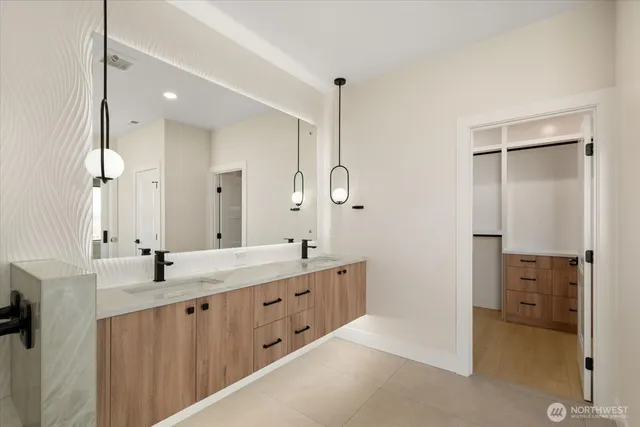 a bathroom with a granite countertop sink mirror and double