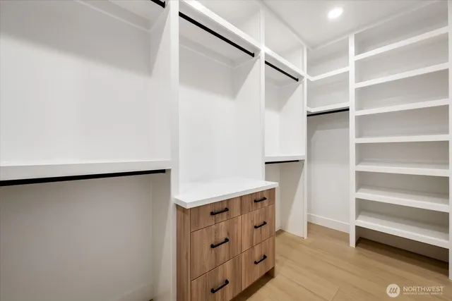 a view of walk in closet with empty racks