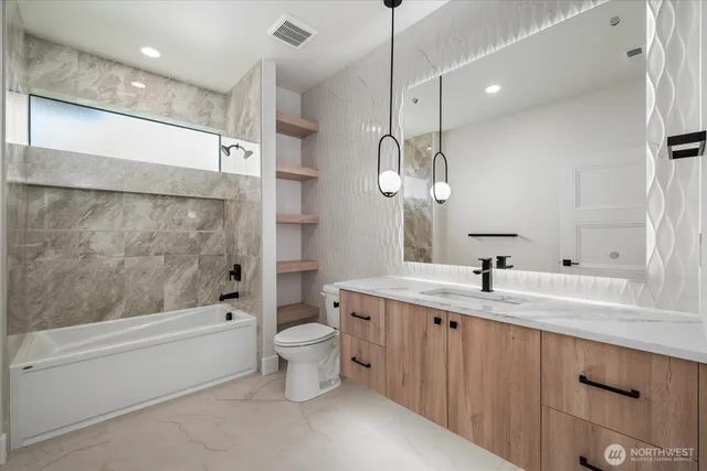a bathroom with a double vanity sink mirror and toilet