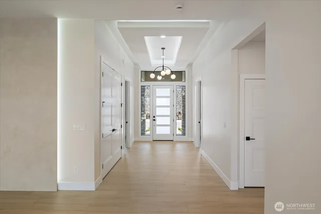 a view of a big room with chandelier and entryway