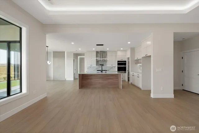 a view of kitchen with kitchen island refrigerator sink and cabinets