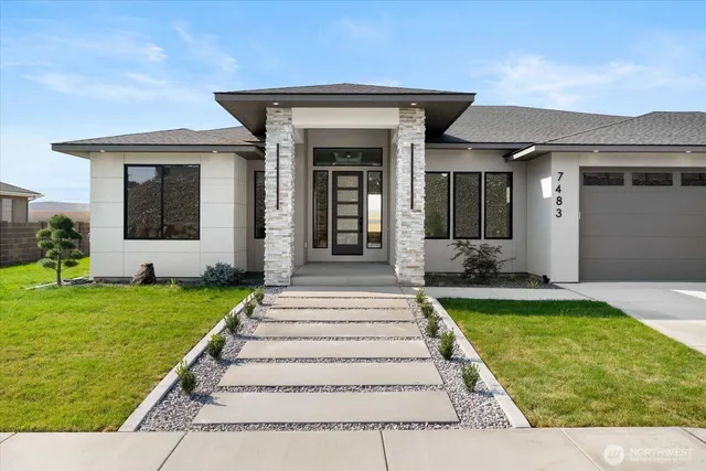 a front view of a house with a yard