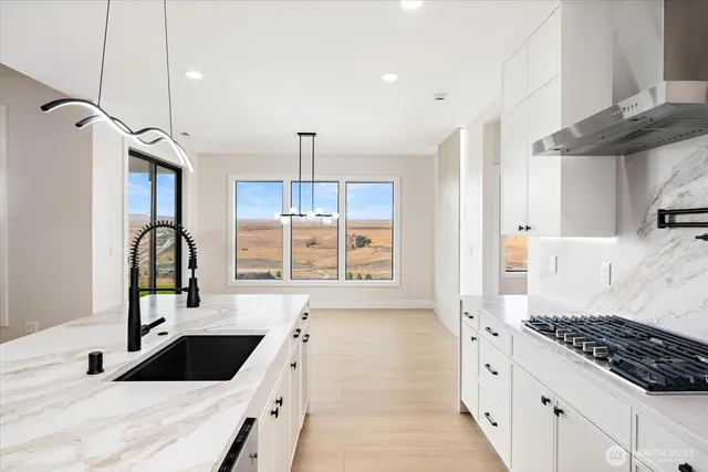 a kitchen with a sink stove and cabinets