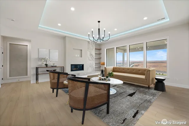 a living room with furniture and a chandelier