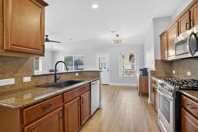 a kitchen that has a sink and a stove