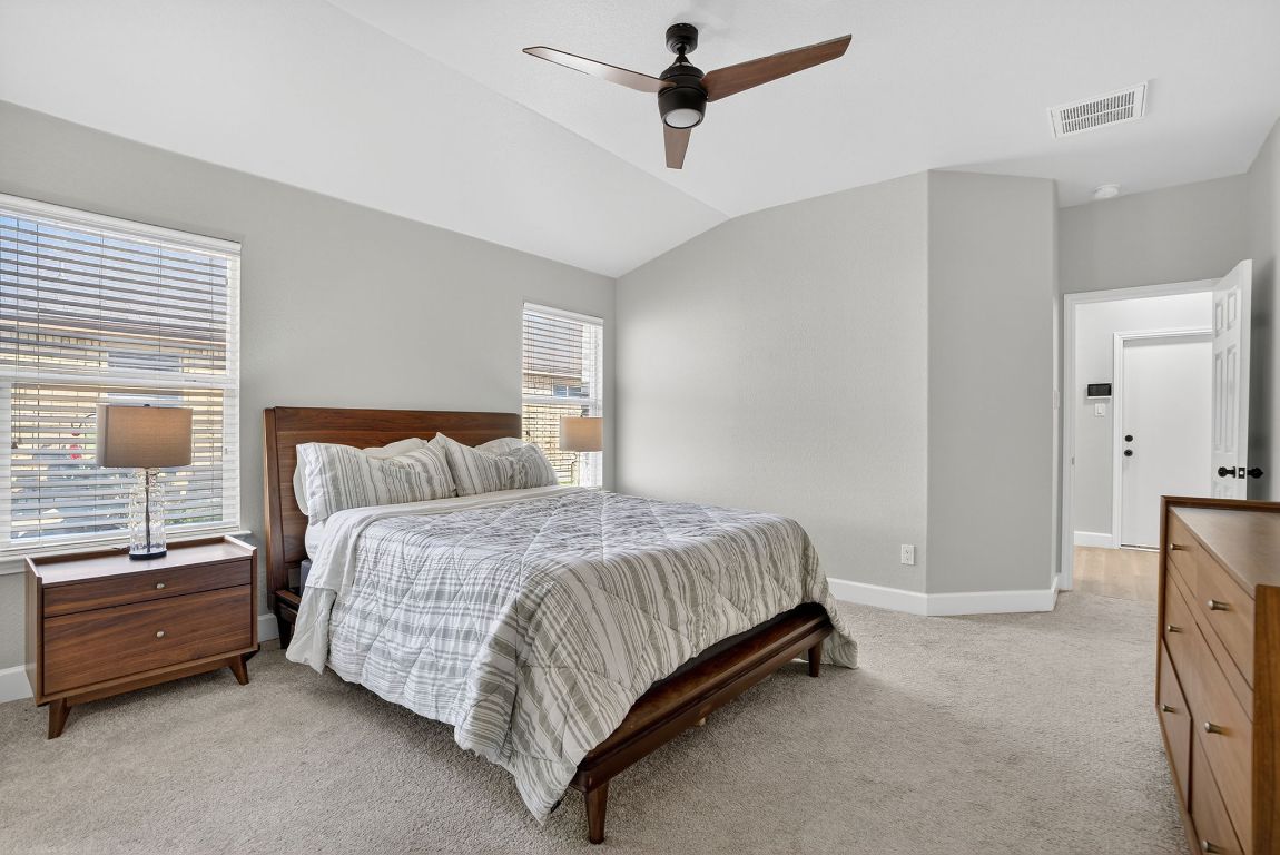 394 Verano Drive Kyle, TX 78640 - Photo 16 of 25 a bedroom with a bed and a window