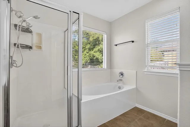 a white bath tub sitting next to a window