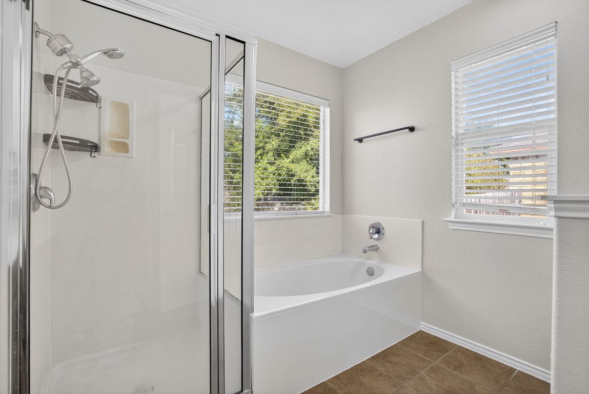 394 Verano Drive Kyle, TX 78640 - Photo 18 of 25 a white bath tub sitting next to a window