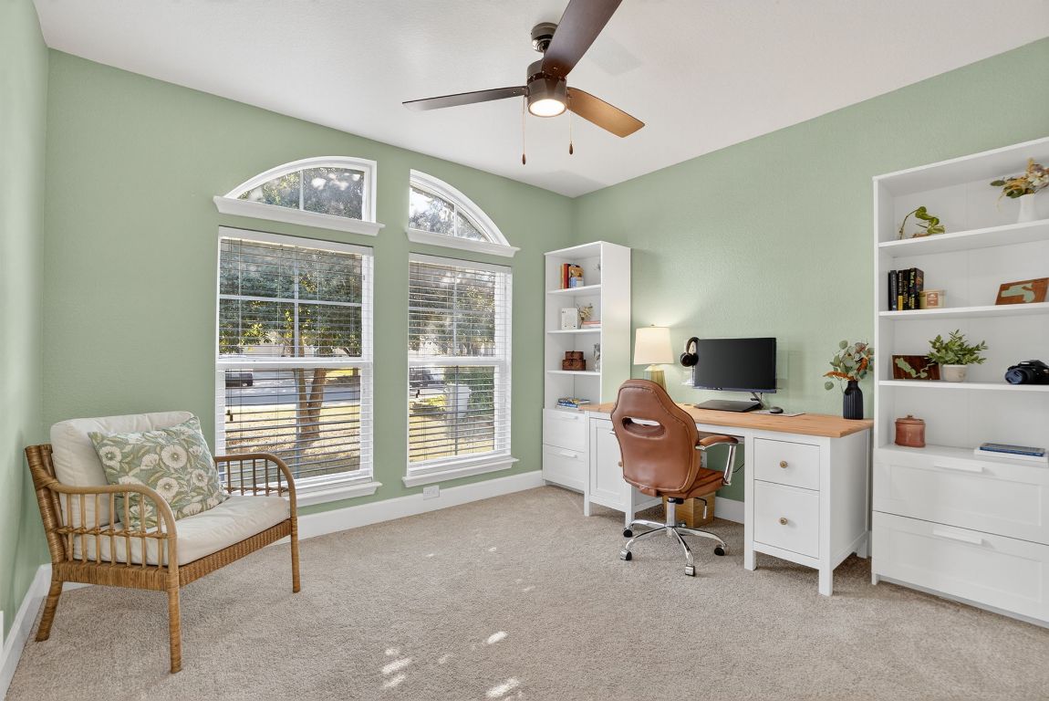 394 Verano Drive Kyle, TX 78640 - Photo 19 of 25 a view of a workspace with furniture and a window