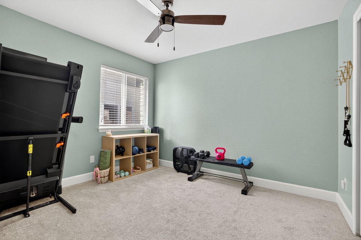394 Verano Drive Kyle, TX 78640 - Photo 20 of 25 a living room with furniture and a flat screen tv