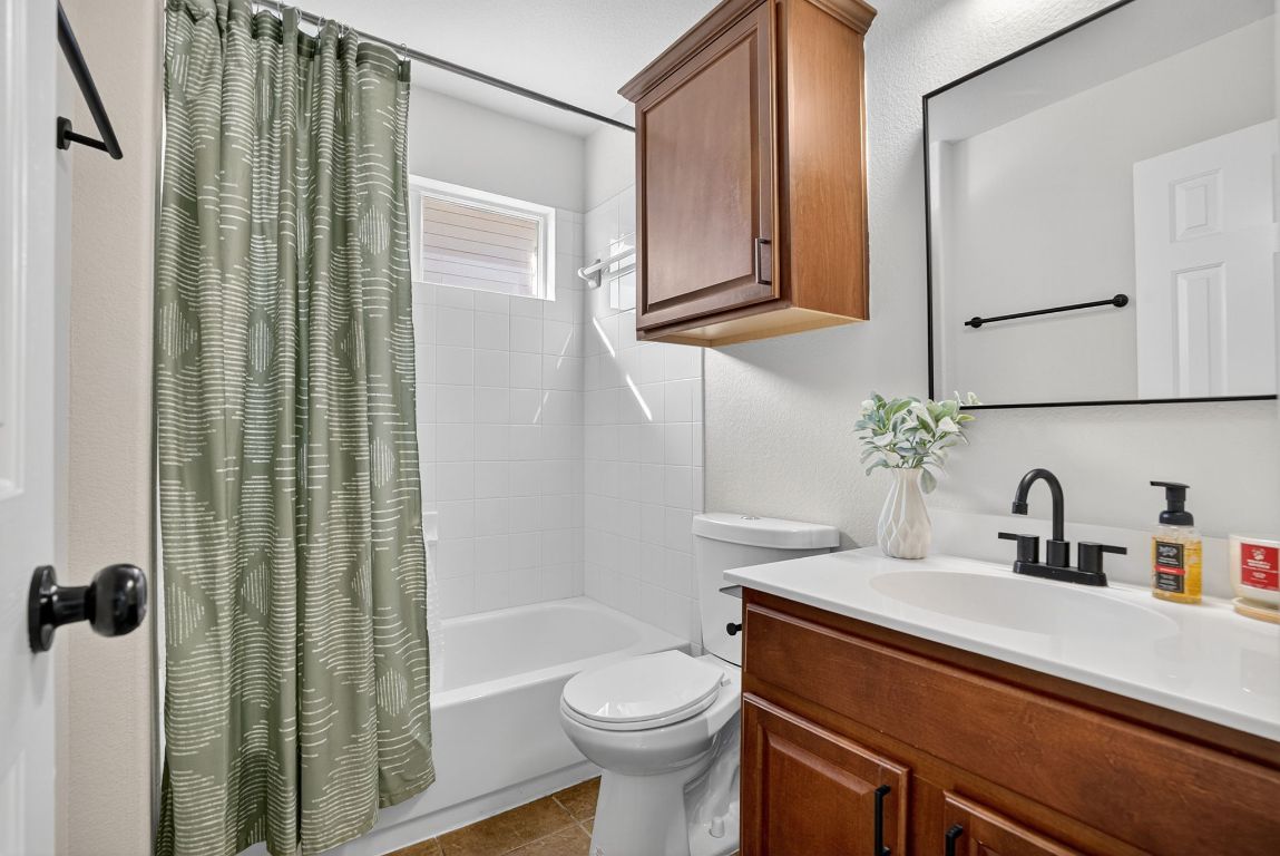 394 Verano Drive Kyle, TX 78640 - Photo 21 of 25 a bathroom with a sink a toilet and shower