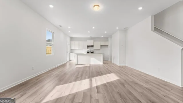 a kitchen with stainless steel appliances granite countertop a sink stove and cabinets