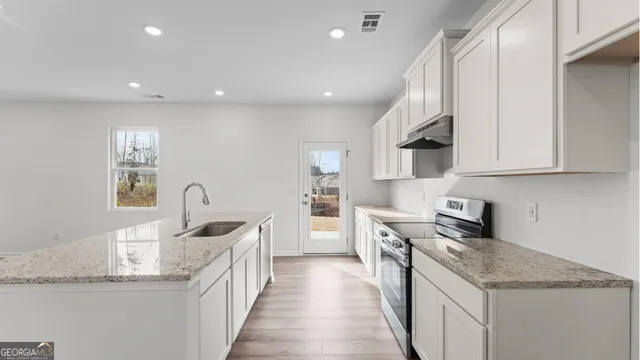 a view of kitchen with sink and natural light