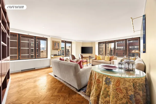 a living room with furniture and large windows